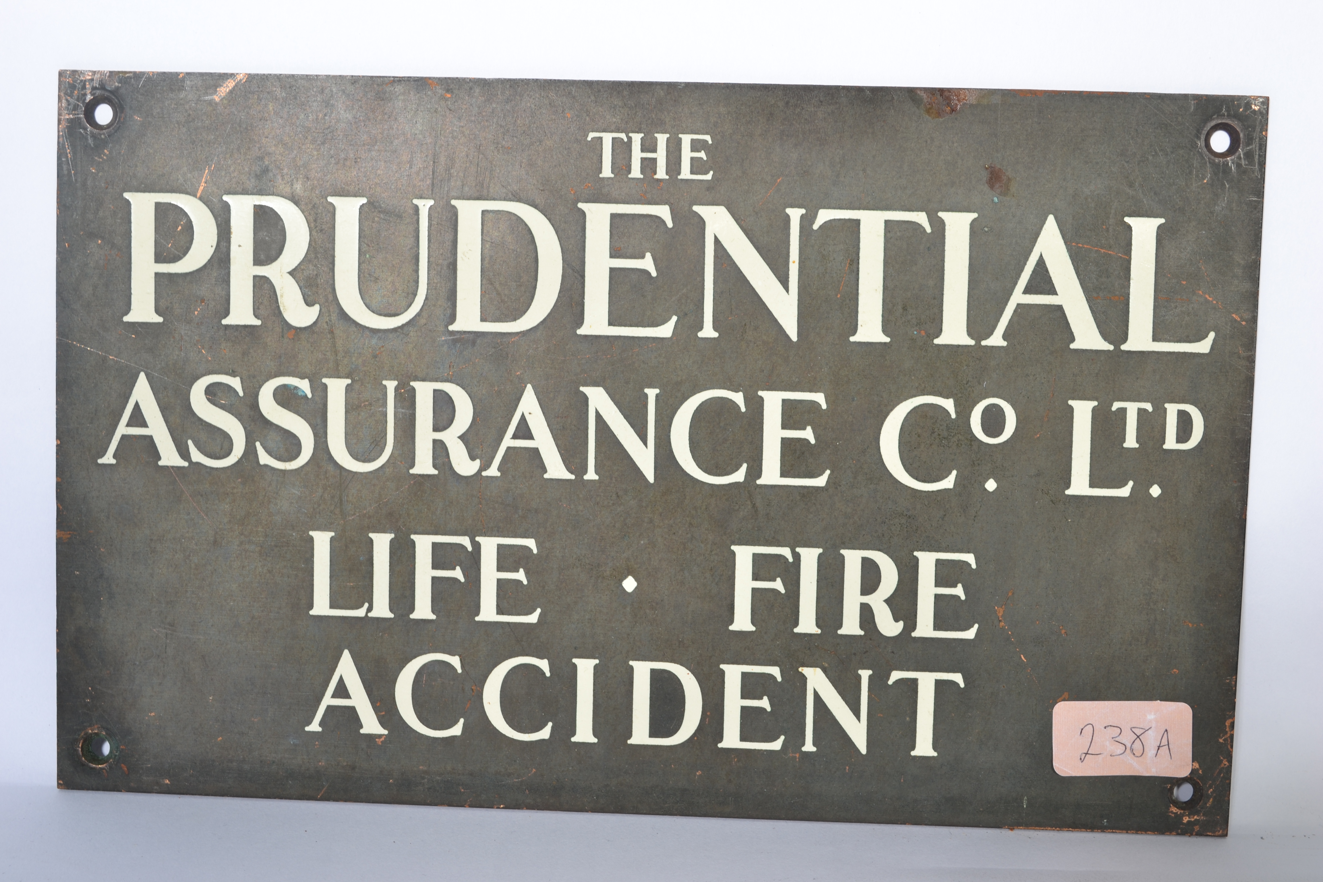 A vintage 20th century bronze and enamel wall plaque for The Prudential Assurance, black ground with