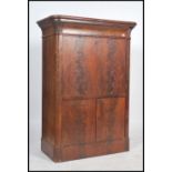 An early 19th century flame mahogany secretaire abattant having a fold out front desk with a