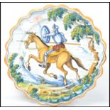 A large 20th century Faience  charger plate of Spanish origin having horse with soldier design being