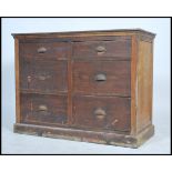 A 1930s/40s haberdashery 6 drawer oak chest of drawers having four deep drawers, with a show wood