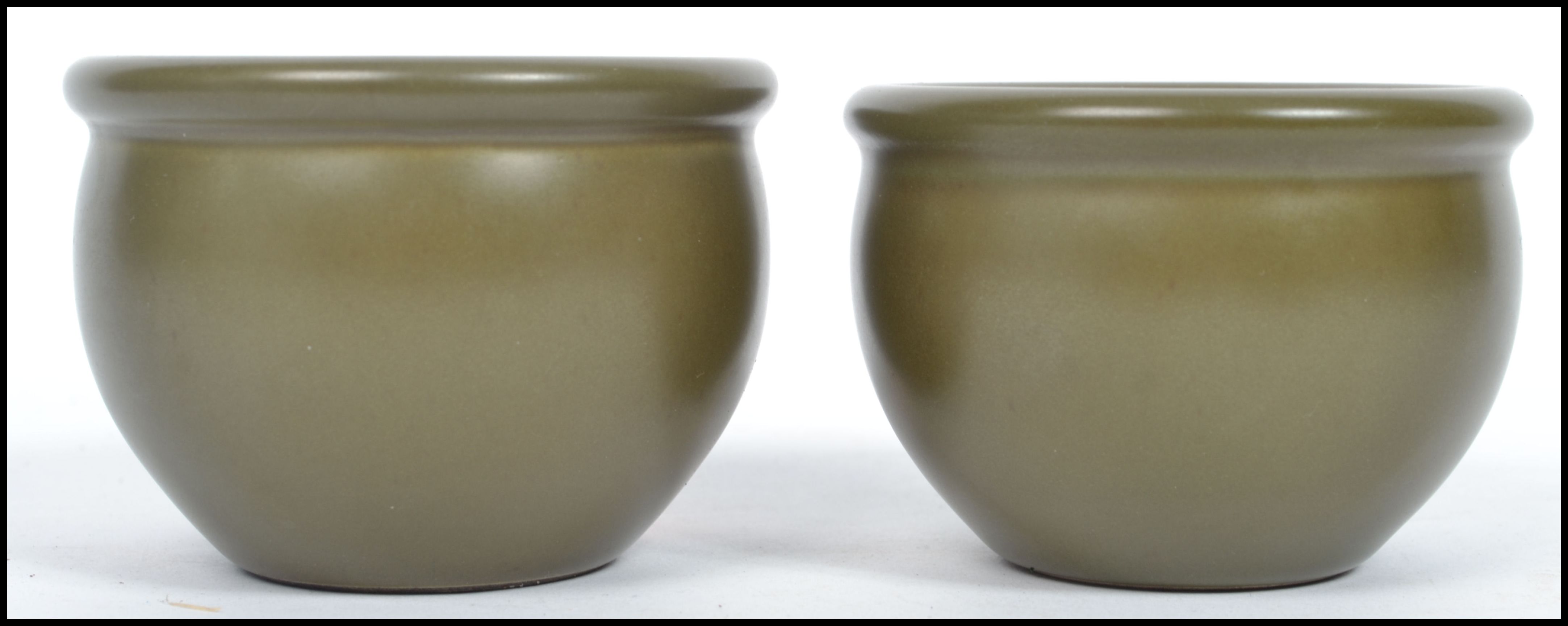 A pair of late 19th century / early 20th century Chinese Kang-xi period green glaze squat bowls each