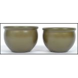 A pair of late 19th century / early 20th century Chinese Kang-xi period green glaze squat bowls each