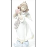 A Lladro ceramic figurine entitled ' Loving The World '  depicting an angel with flowers to hair