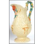 A Clarice Cliff Celtic Harvest pattern jug with fruit handle and wheatsheaf decoration, with printed