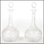 A pair of 19th century cut glass decanters having bulbous bodies with hand engraved decoration,