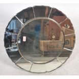 A vintage large Art Deco bevelled glass mirror of circular form having a central circular panel with