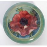 A 20th century Moorcroft ceramic bowl of short form having a turquoise green ground with painted and