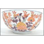 A large Oriental ceramic bowl having a white ground with decoration of birds and flowers having