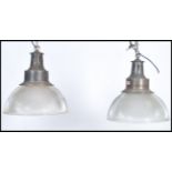 A pair of vintage 20th century Art Deco glass pendant shades light fixtures having brass fittings.