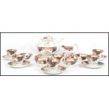 A good early 20th century tea service in an Imari pattern with bubble decorations. The set
