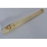 A 19th century ivory cheroot of tapering form with carved winged beetle scarab to top.