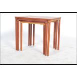 A good Danish 1960's teak wood graduating nest of tables being raised on turned legs with a series