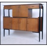 A mid 20th century retro / vintage tall sideboard cocktail cabinet, the sideboard raised on an