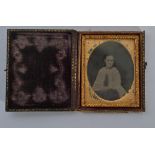 A 19th century Victorian ambrotype of a girl set in an ornate gilt frame housed within the