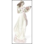 A Lladro ceramic figurine of a lady holding a basket of fruit and flowers entitled Autumn Romance