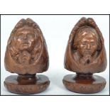 A pair of unusual carved wooden bookends in the form of winged angels in prayers raised on