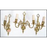 A set of three cast brass early 20th century scrolled wall sconces in the 17th century Dutch