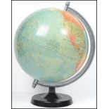 A retro 20th century vintage 1978 political desk top globe being raised on an ebonised plinth base.