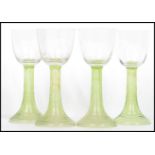 A group of four early 20th century Hock wine glasses, each glass raised on a ribbed tapering stem