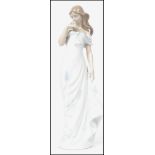 A Lladro ceramic figurine entitled ' A Flowers Whisper ' depicting a lady in a dress holding a