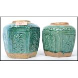 A pair of Oriental Chinese ceramic stoneware ginger gars of hexagonal form having a green glaze