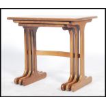 A vintage retro 20th century G-Plan nest of tables having square tops with played legs united by