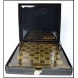 A Manopoulos classical style chess set with gilt metal and silvered metal pieces, with chess board