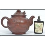 An Oriental Yi Xing terracotta teapot having a metamorphic dragon to body with moving head and