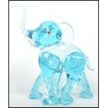 An unusual 20th century / 1960's retro glass elephant figurine. Blue glass with colourful eyes and