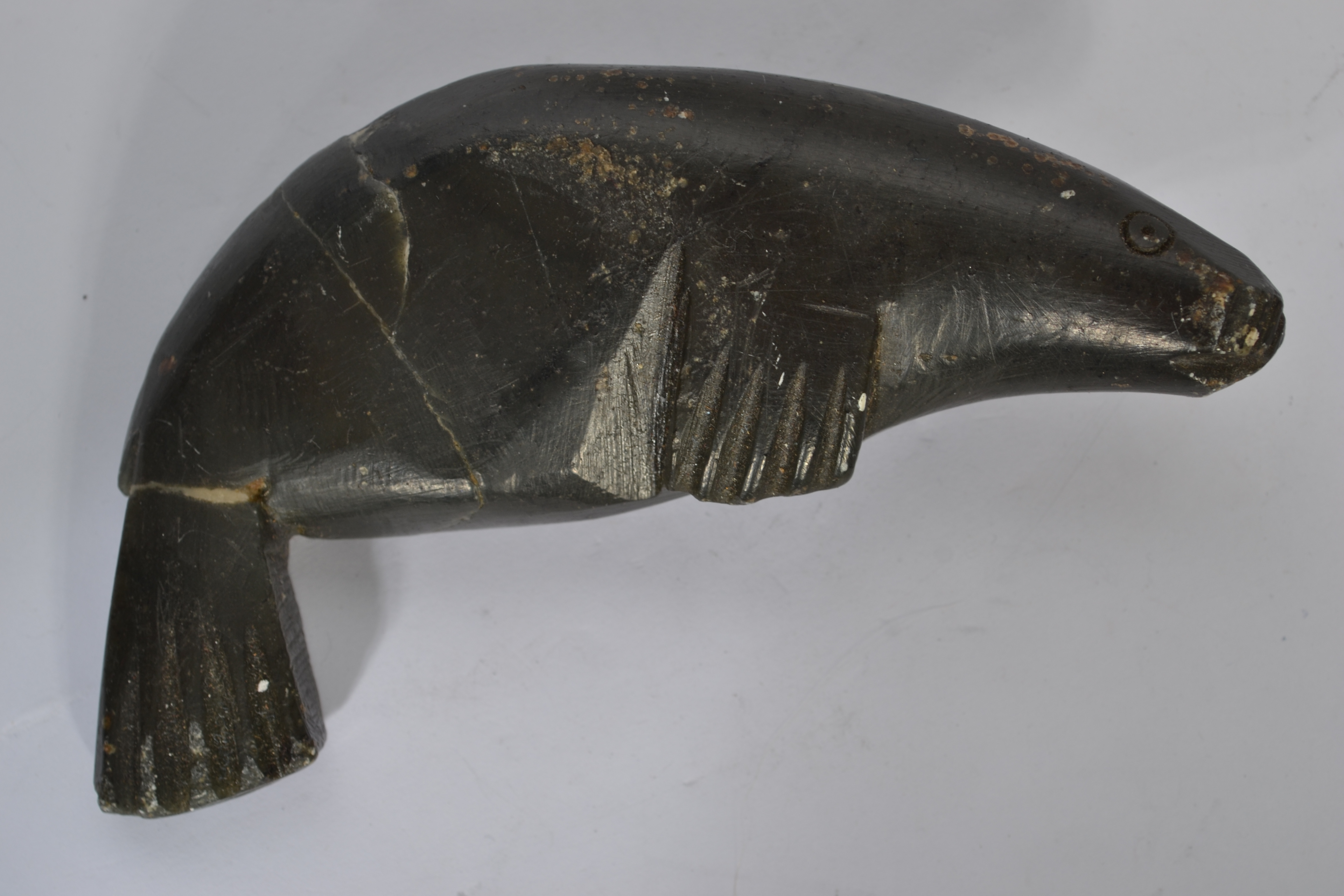 An early 20th century Inuit soapstone carving of a