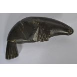 An early 20th century Inuit soapstone carving of a