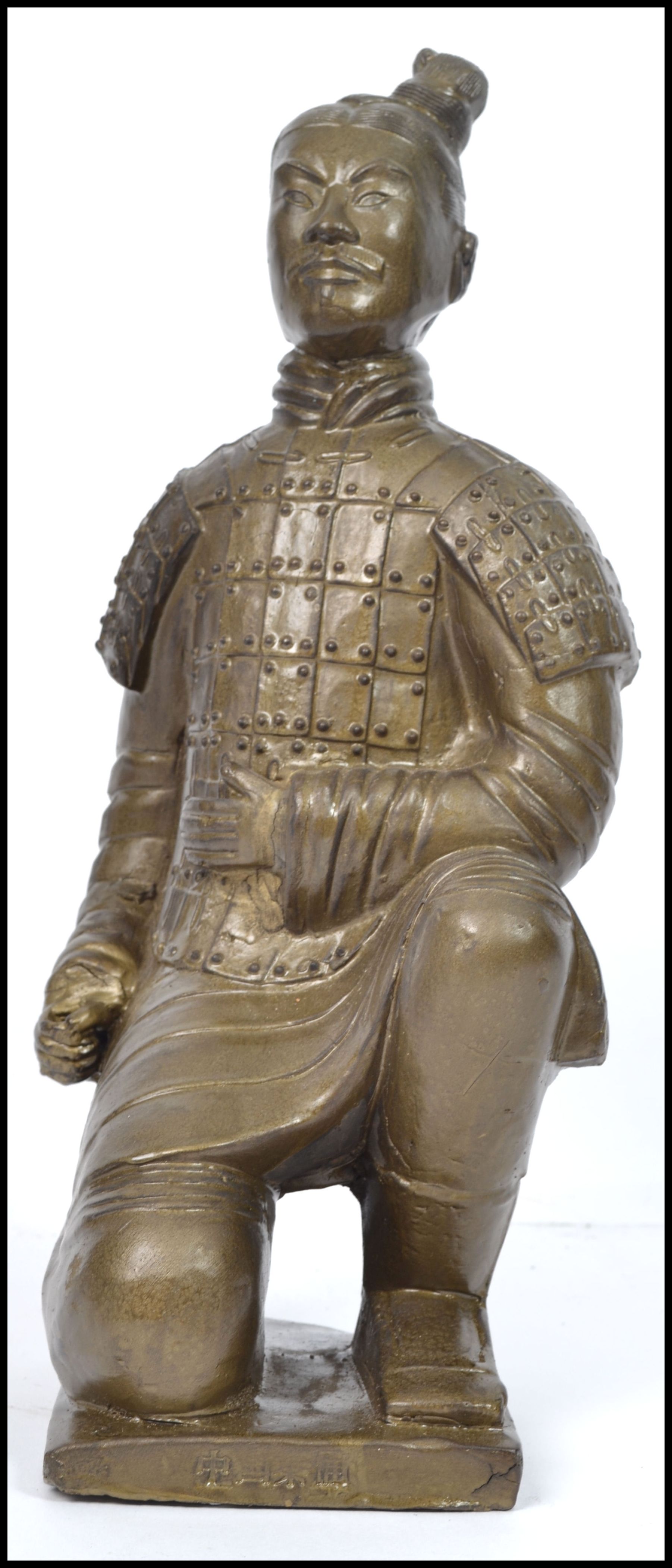 A large gilded plaster Chinese figurine of a terra