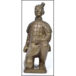 A large gilded plaster Chinese figurine of a terra