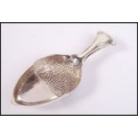 A sterling silver caddy spoon in the form of an ac