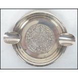 A silver ashtray of circular form, central Mayan d