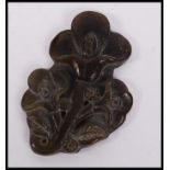 An Oriental carved jade carving depicting blossomi