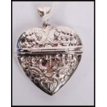 A silver white metal heart shaped vesta case with