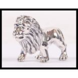 A sterling silver figurine of a male lion with det