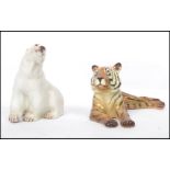 A Branksome china polar bear figurine together with a Midwinter figurine of a tiger. Both with