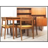 A 1970's retro Danish inspired teak wood dining room suite comprising round extending dining table