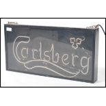 A retro 20th century shop advertising point of sale neon sign for Carlsberg. The neon being housed
