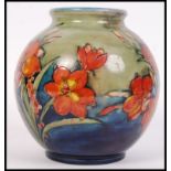 A good 1930's Moorcroft pottery bulbous shaped vase being decorated in the Freesia pattern having