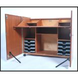 A 1970's retro teak wood office Industrial cube desk - filing cabinet having twin doors, raised on