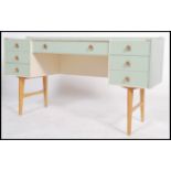 A vintage 20th century up cycled two tone painted twin pedestal knee-hole desk having an arrangement