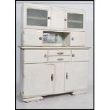 A 1930's Art Deco painted French kitchen dresser cabinet. The base with shaped bracket feet