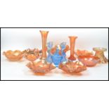 A good collection of 20th century orange lustre carnival glass to include handkerchief bowls, tazza,