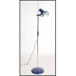 A retro 20th century floor standing floor lamp / light, raised on a blue circular base with an