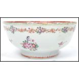 An 18th / 19th century Chinese famille rose bowl of circular form being handpainted with floral