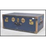 A vintage 20th century steamer trunk, hinged lid studded detail finish and in the original blue.