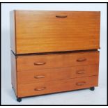 A retro teak wood ladderax style cabinet raised on castors together with another modular part,